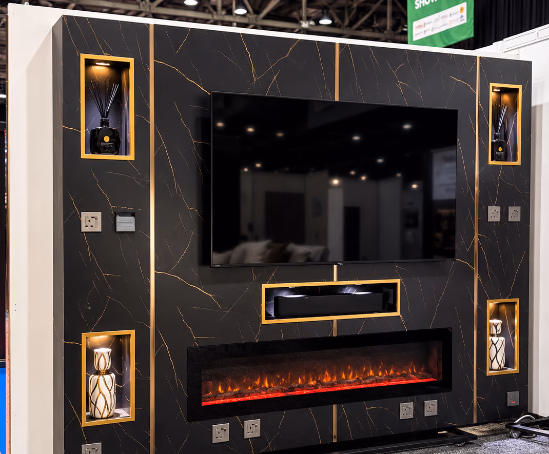 Black and gold marble media wall with a TV, soundbar recess, wide electric fire and four gold-framed lit niches
