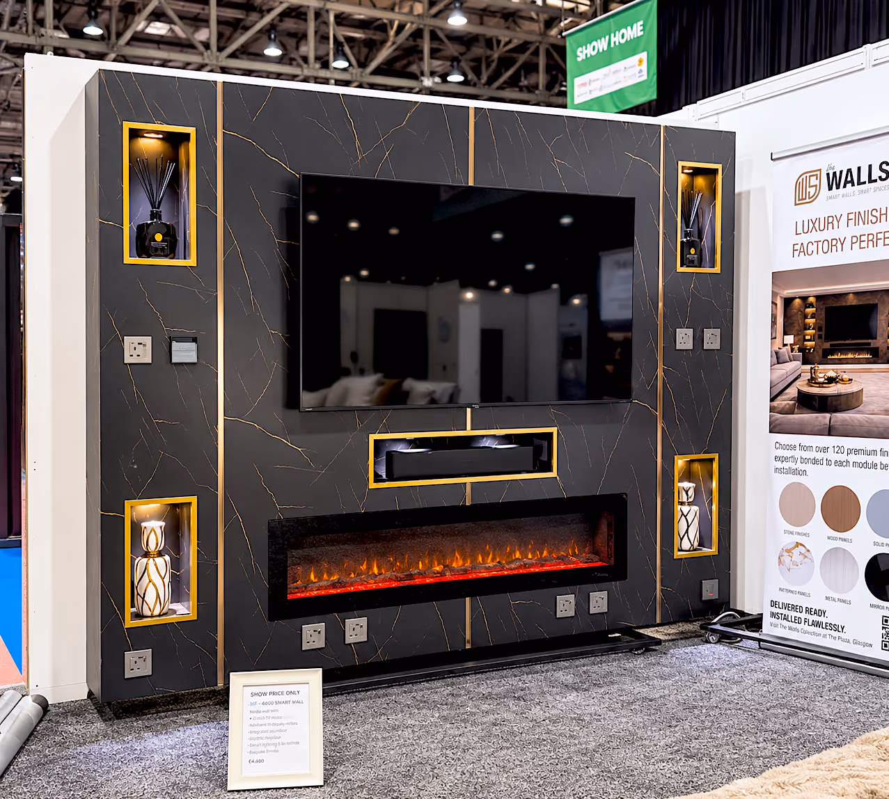 Black and gold marble media wall with a TV, soundbar recess, wide electric fire and four gold-framed lit niches