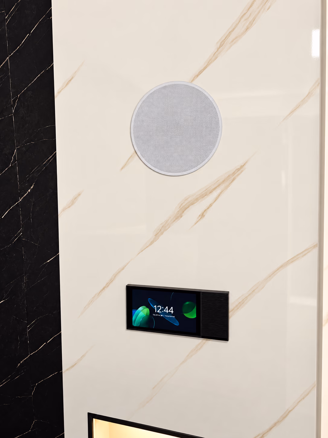 Flush round in-wall speaker above a smart home control panel set into a white marble wall panel